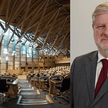 Image shows the Scottish Parliament and Cabinet Minister Angus Robertson
