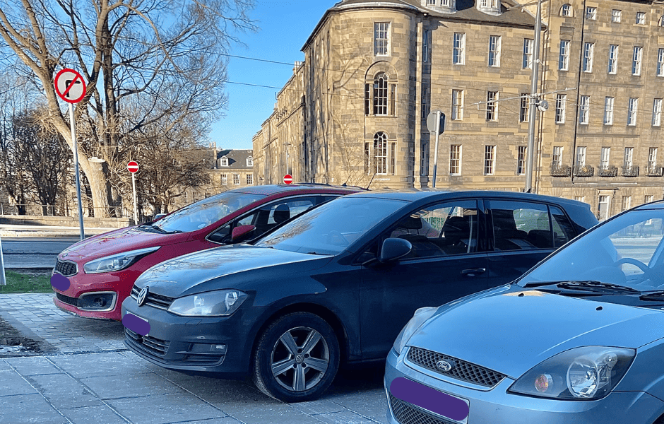 cars parked on pavement in Edinburgh