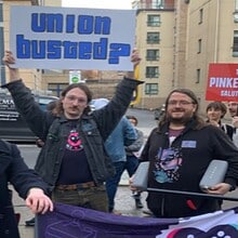 Protesters outside Rockstar Games' Edinburgh office hold up 'union busted?' sign. Courtesy of The Edinburgh Reporter.